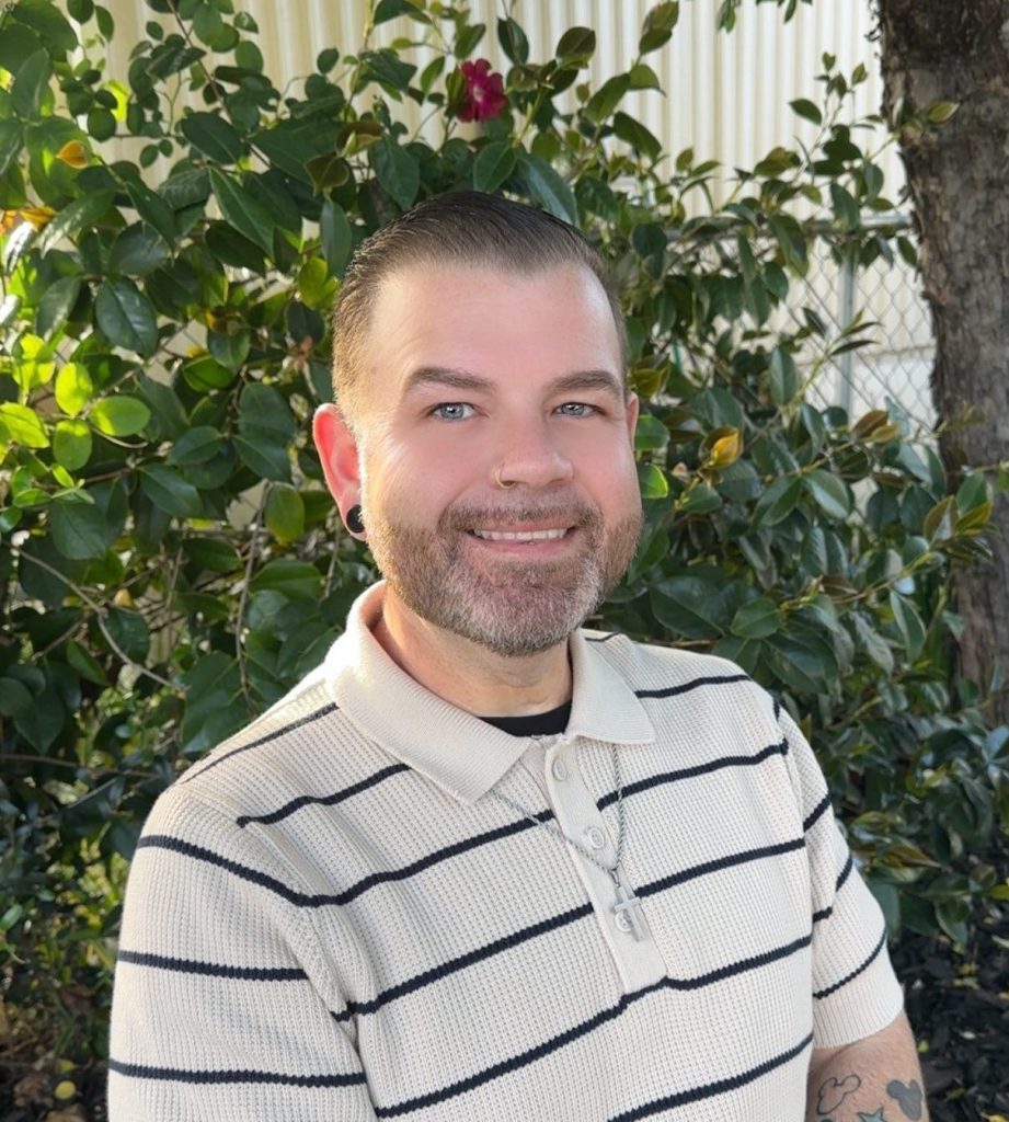 A caucasian man in a striped shirt