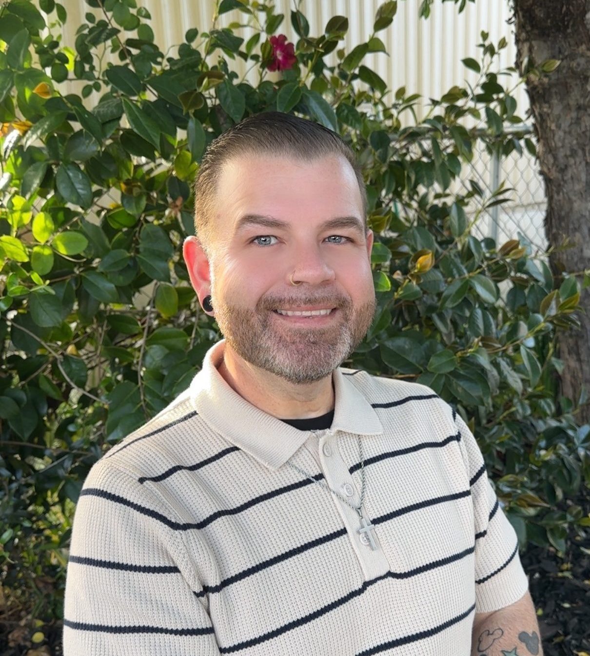 A caucasian man in a striped shirt