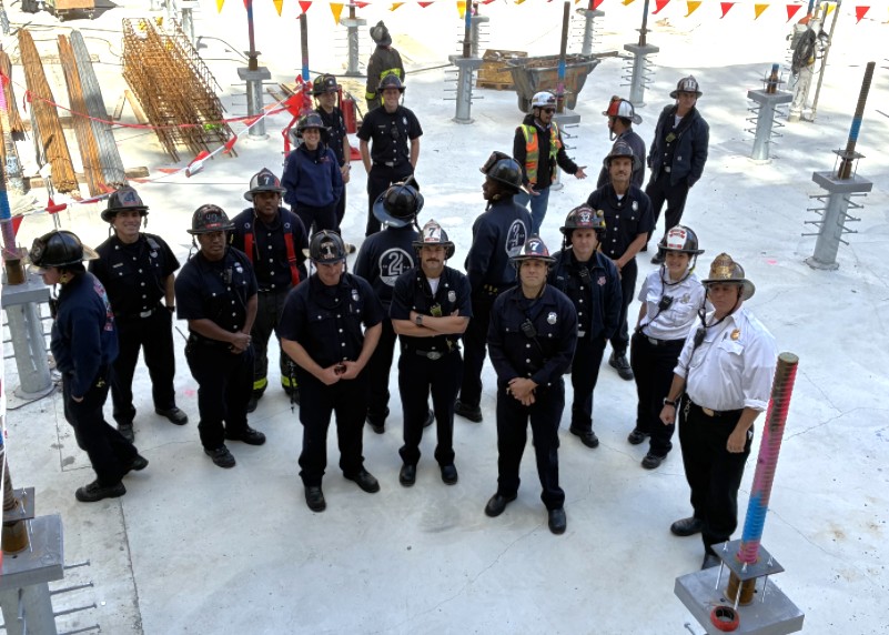 Group of firefighters stand dressed in offduty uniforms