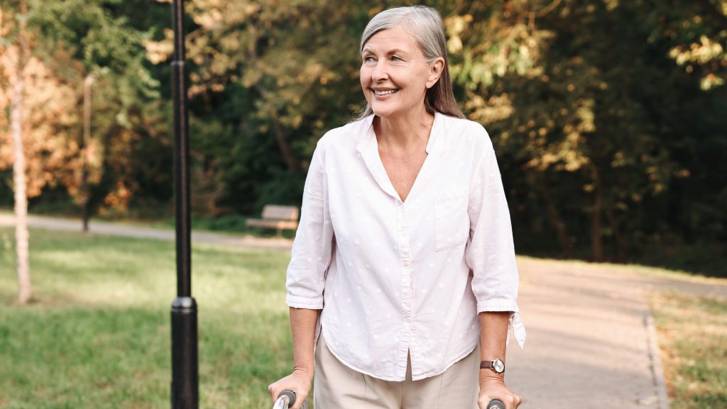 Senior woman with walking frame in park
