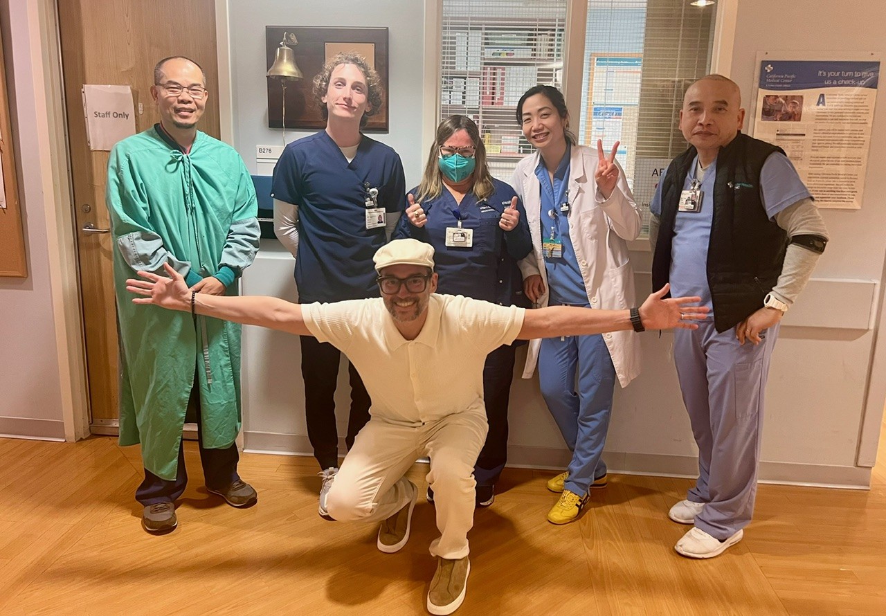 A man celebrates the end of his chemotherapy with his care team
