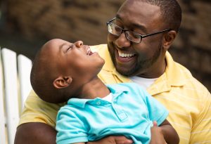 Dad and son talking and laughing