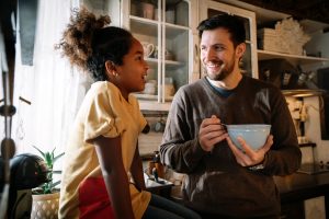 Daughter and dad talking in kitchen