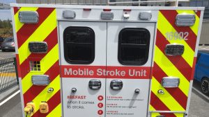 Rear doors of specialized ambulance highlighted with bright red and fluorescent yellow stripes