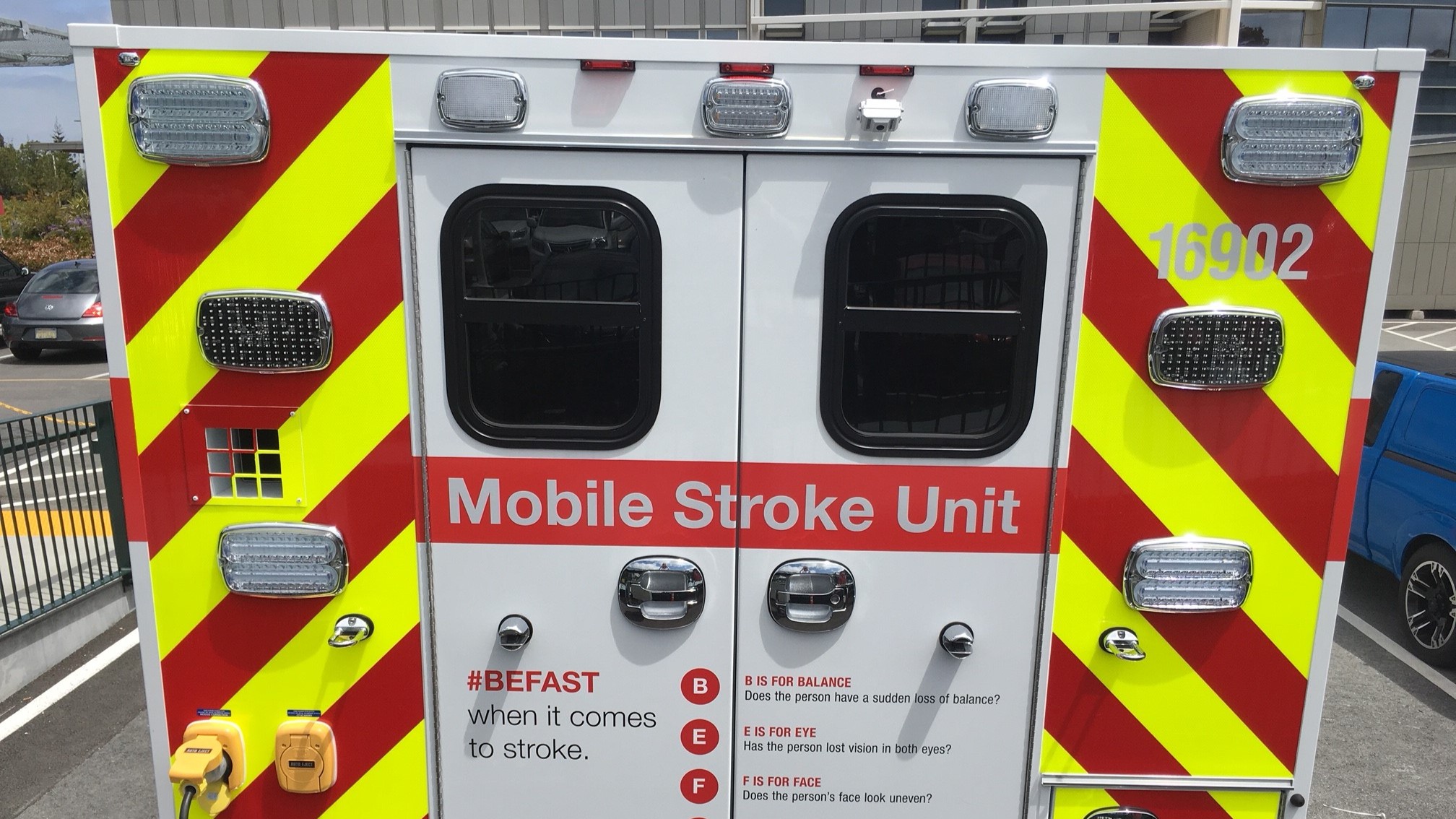 Rear doors of specialized ambulance highlighted with bright red and fluorescent yellow stripes