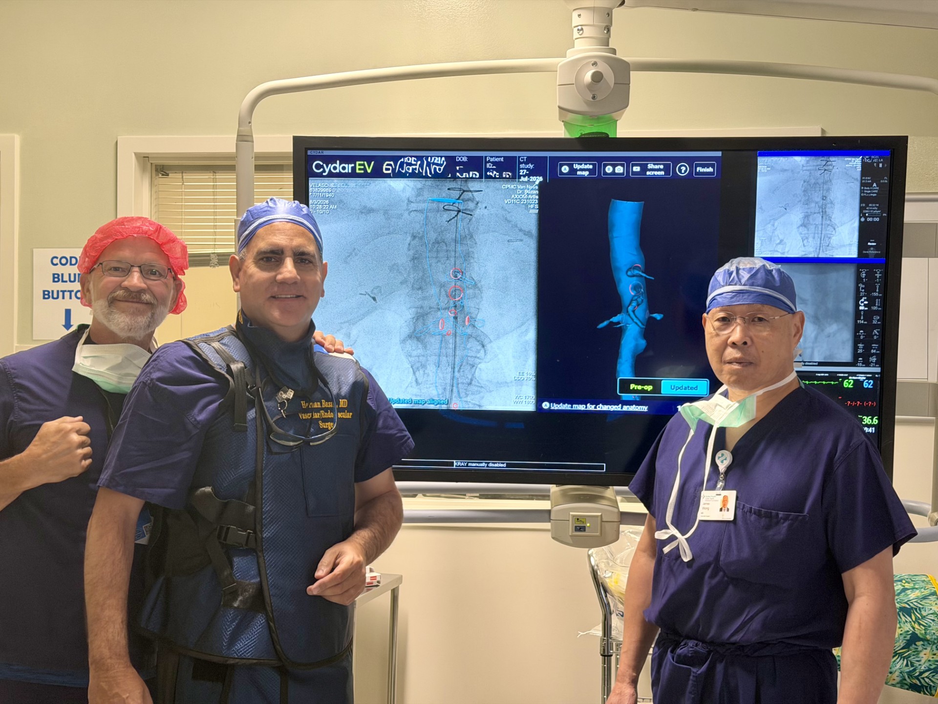 Doctors in surgical gowns stand in front of visualization medical equipment