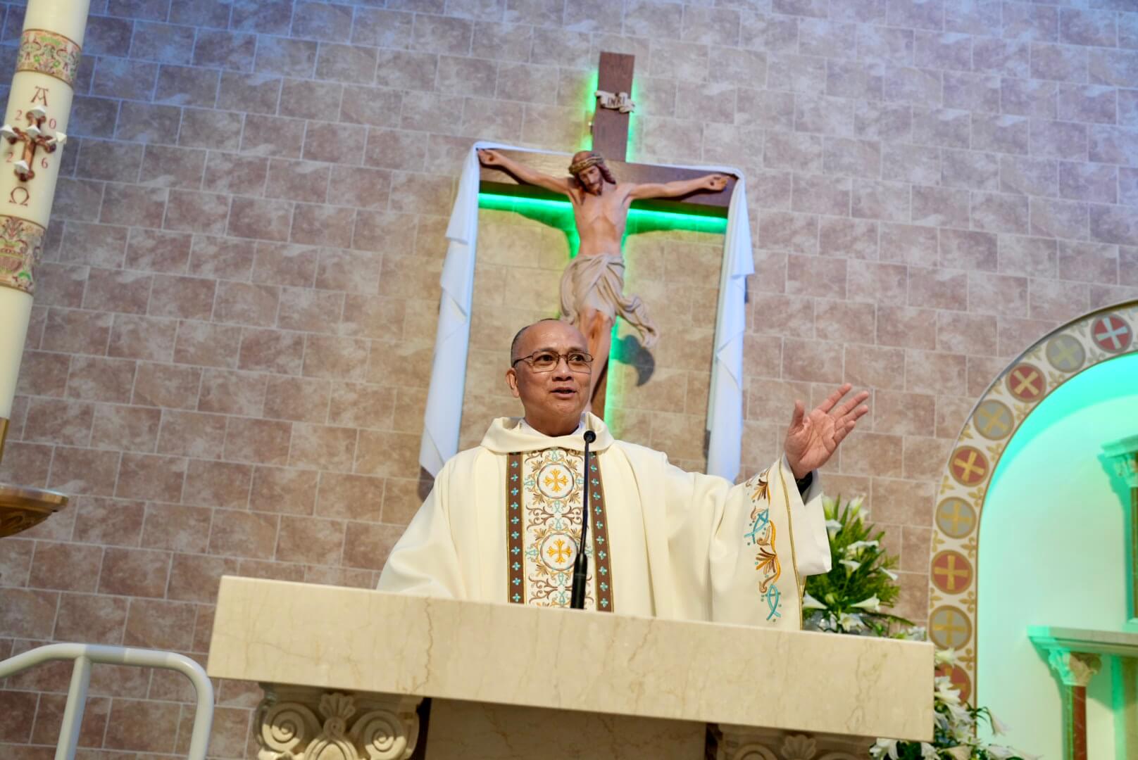 A priest stands at the pulpit