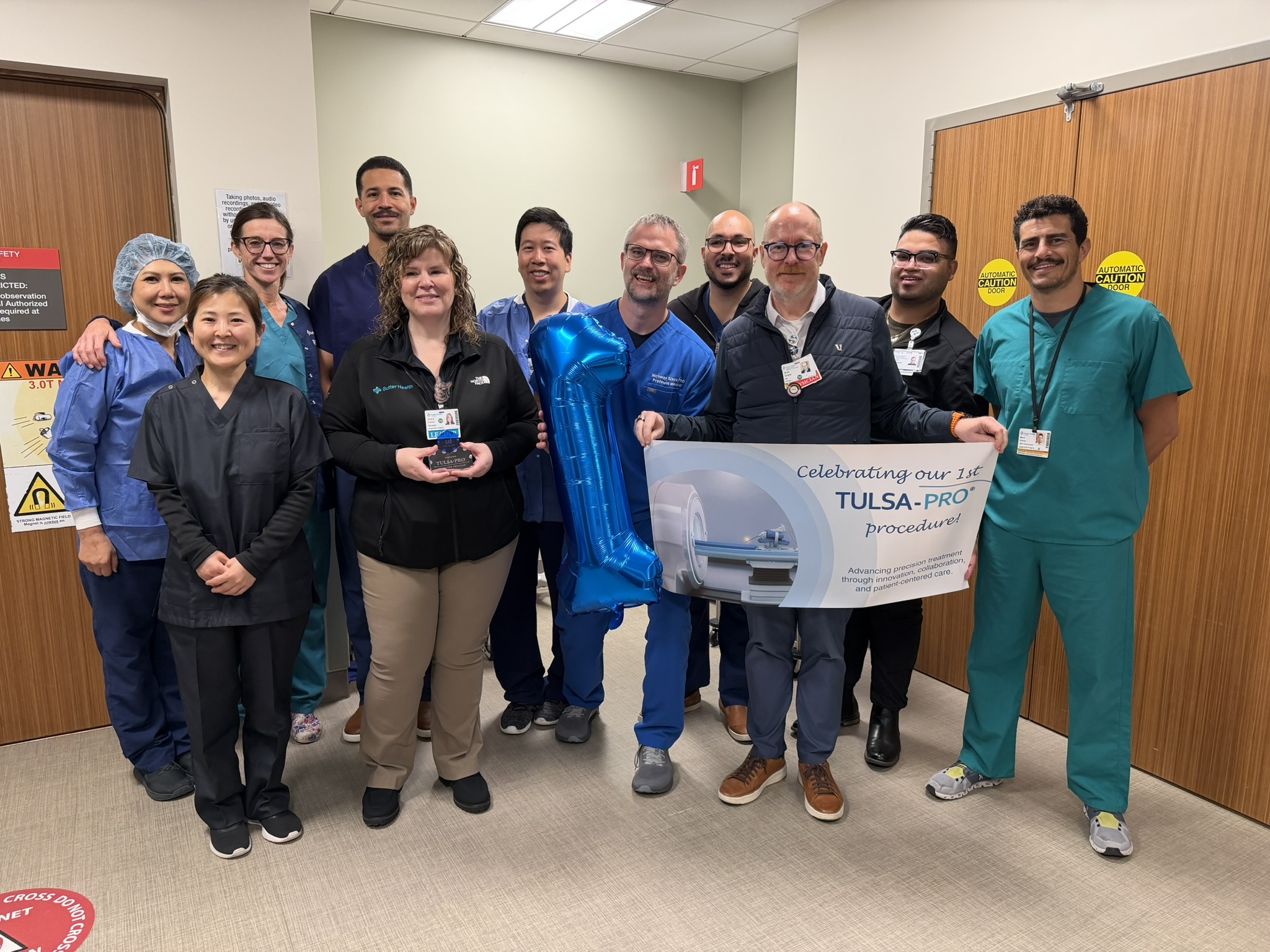 a group of clinicians stand together with a sign that reads TULSA-PRO®