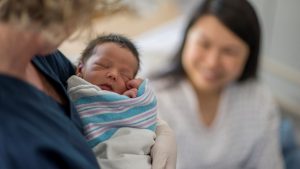 Newborn baby being held
