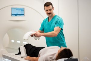 Radiology technician preparing a patient for MRI scan