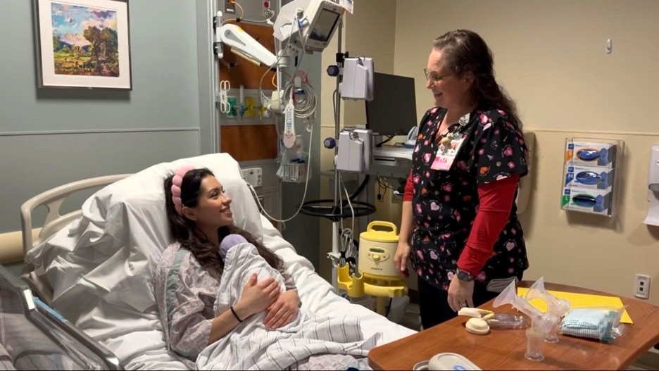 a nurse with a patient and her baby in the hospital