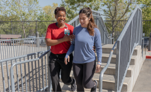 Sutter clinician helping patient with steps