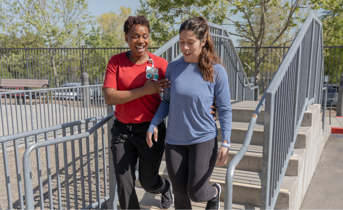 Sutter clinician helping patient with steps