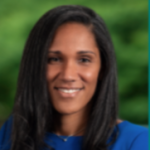 Woman smiling with dark hair and blue shirt on