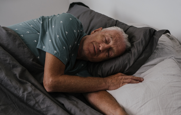 man sleeping in bed