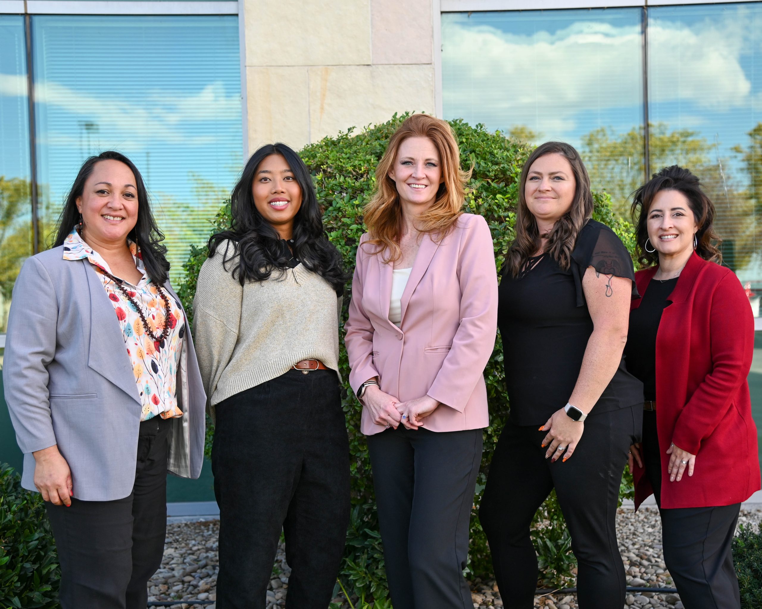 Jennifer Burgon and Team Five female Sutter employees standing in front of a building