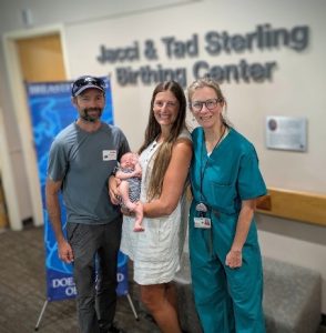 Patrick Robinson, Remy, and Roxanne Beltran visit with Dr. Peggy Moore at a follow-up appointment.