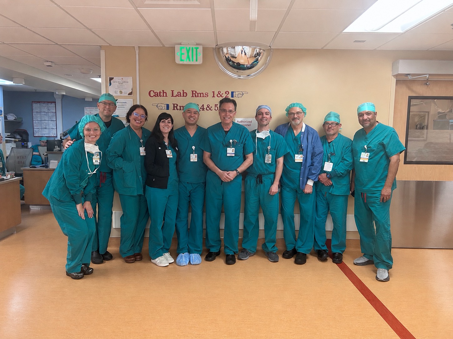 Group shot of doctors and nurses wearing teal scrubs