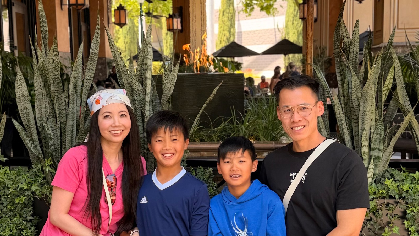 Vitals_Hero1_horizontal Family portrait of Vicky Pan with her husband and two sons.
